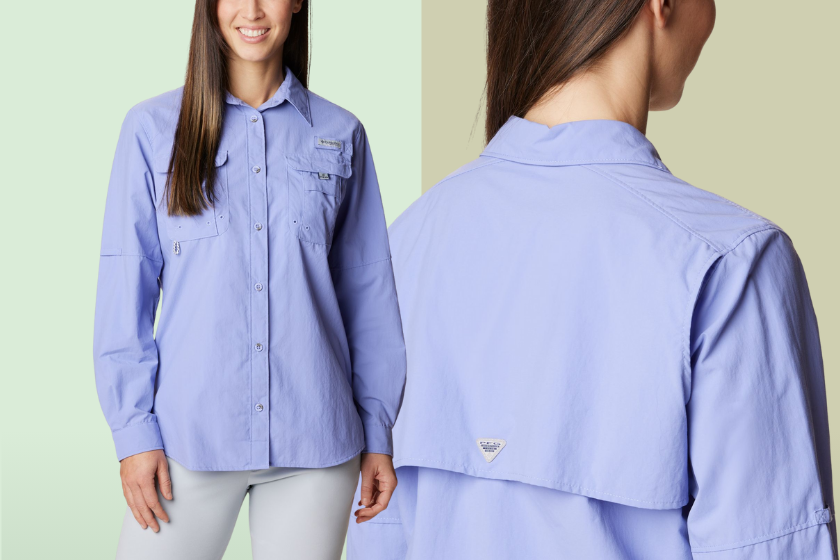 A person wearing a light blue Columbia tshirt on a mint green background