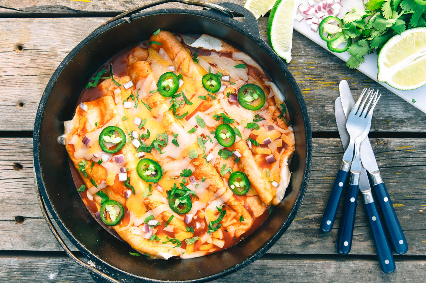 A skillet with enchiladas inside 