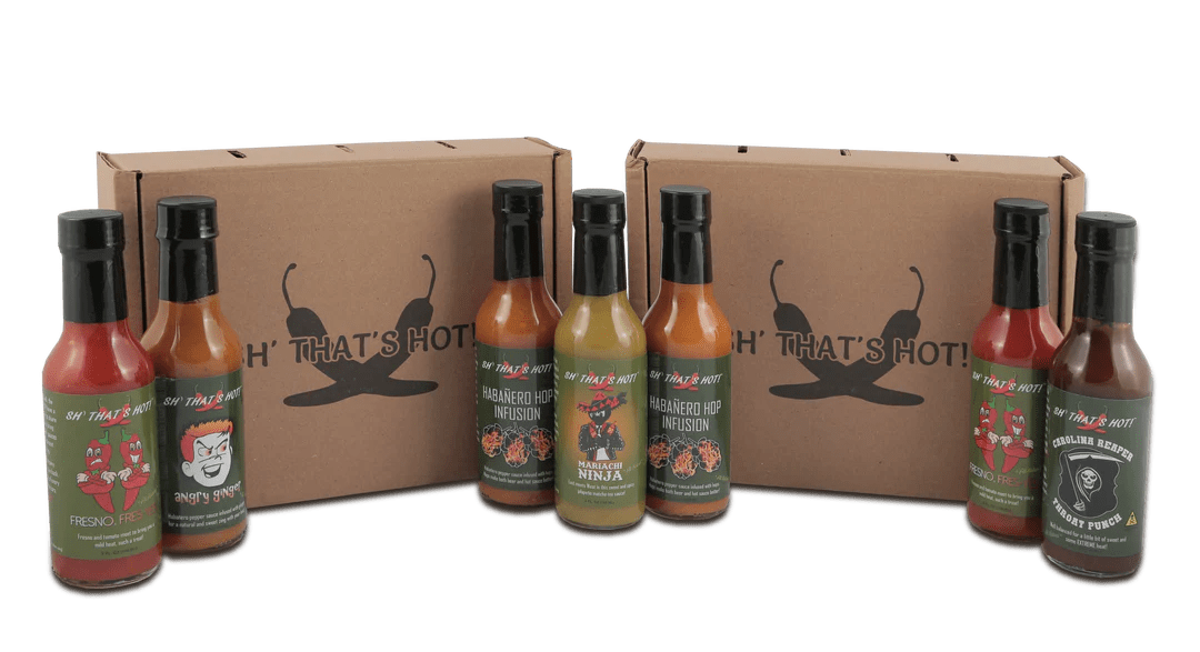 Several different bottles of Sh! That's Hot Hot Sauce