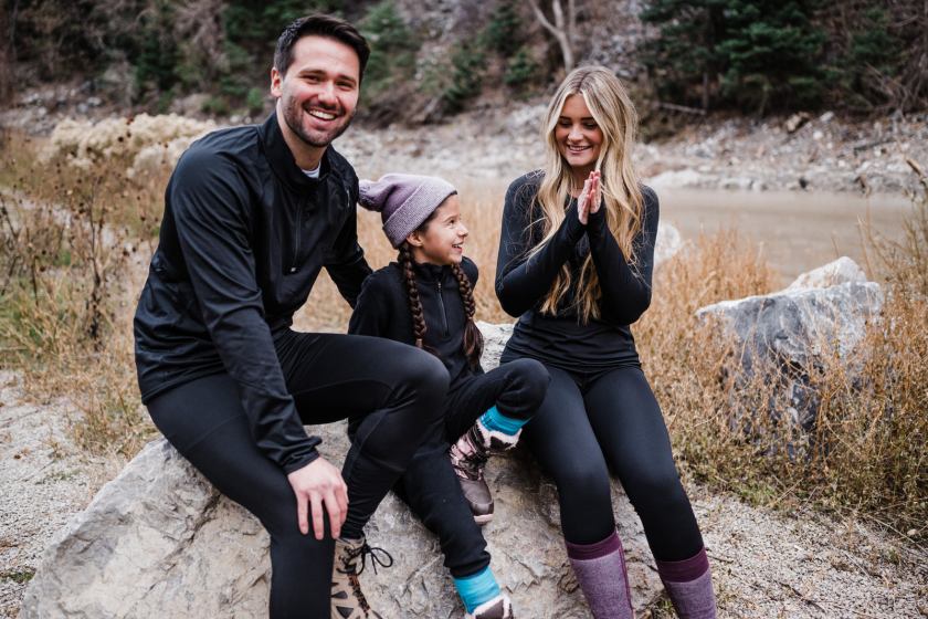 Two adults and a child wearing black clothing from Hot Chillys