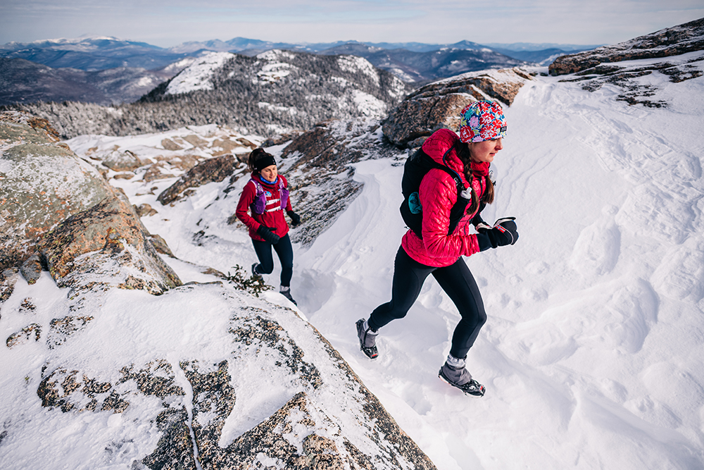 Two people hiking wearing shoes with Kahtoola Spikes
