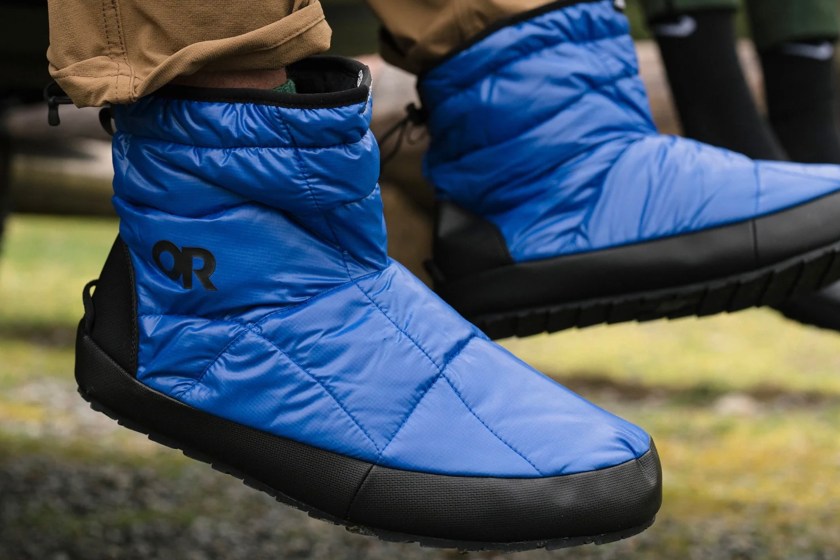 Person's feet dangling while wearing the Outdoor Research Tundra Trax Booties