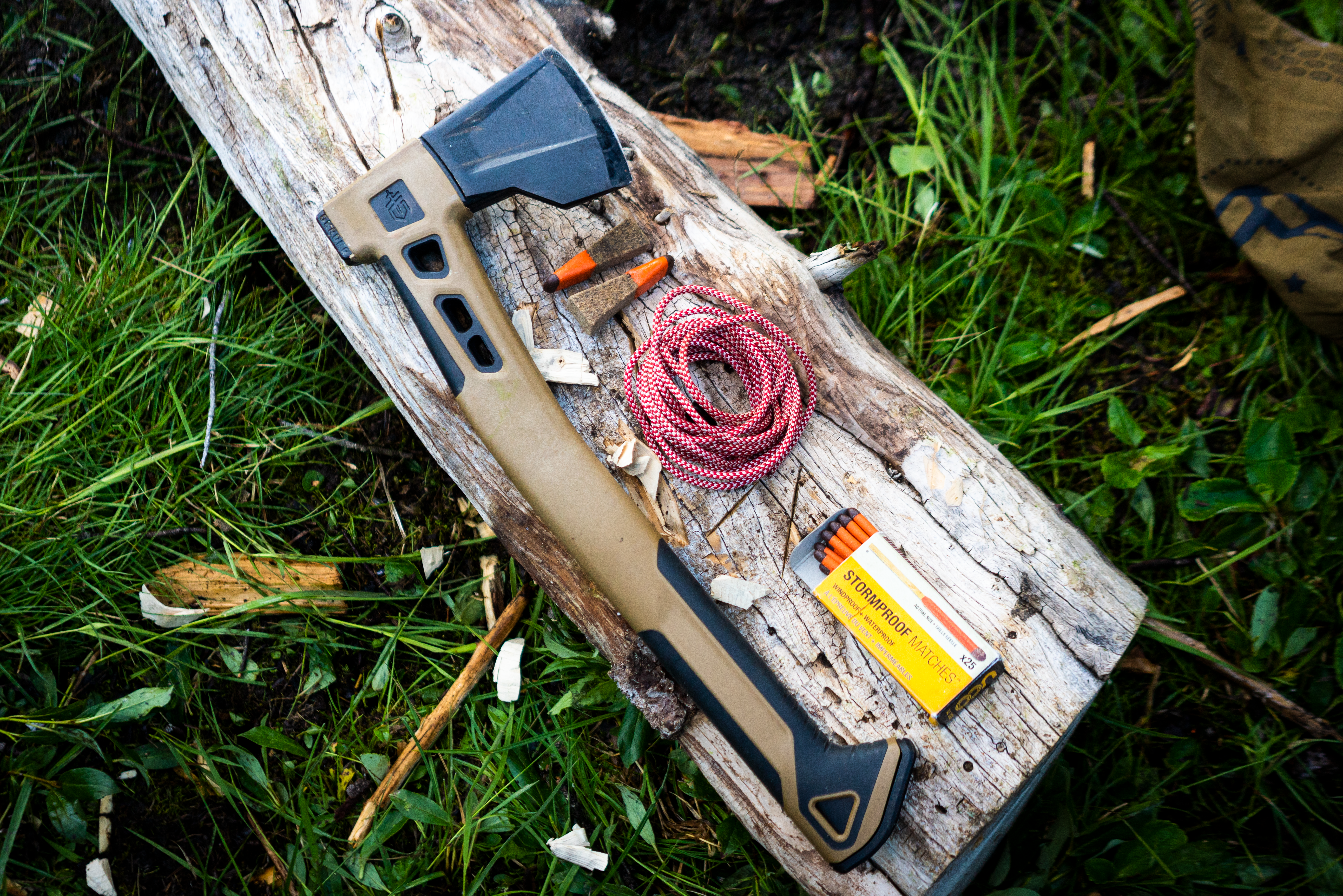 A hatchet with a blue top rested on a wooden surface