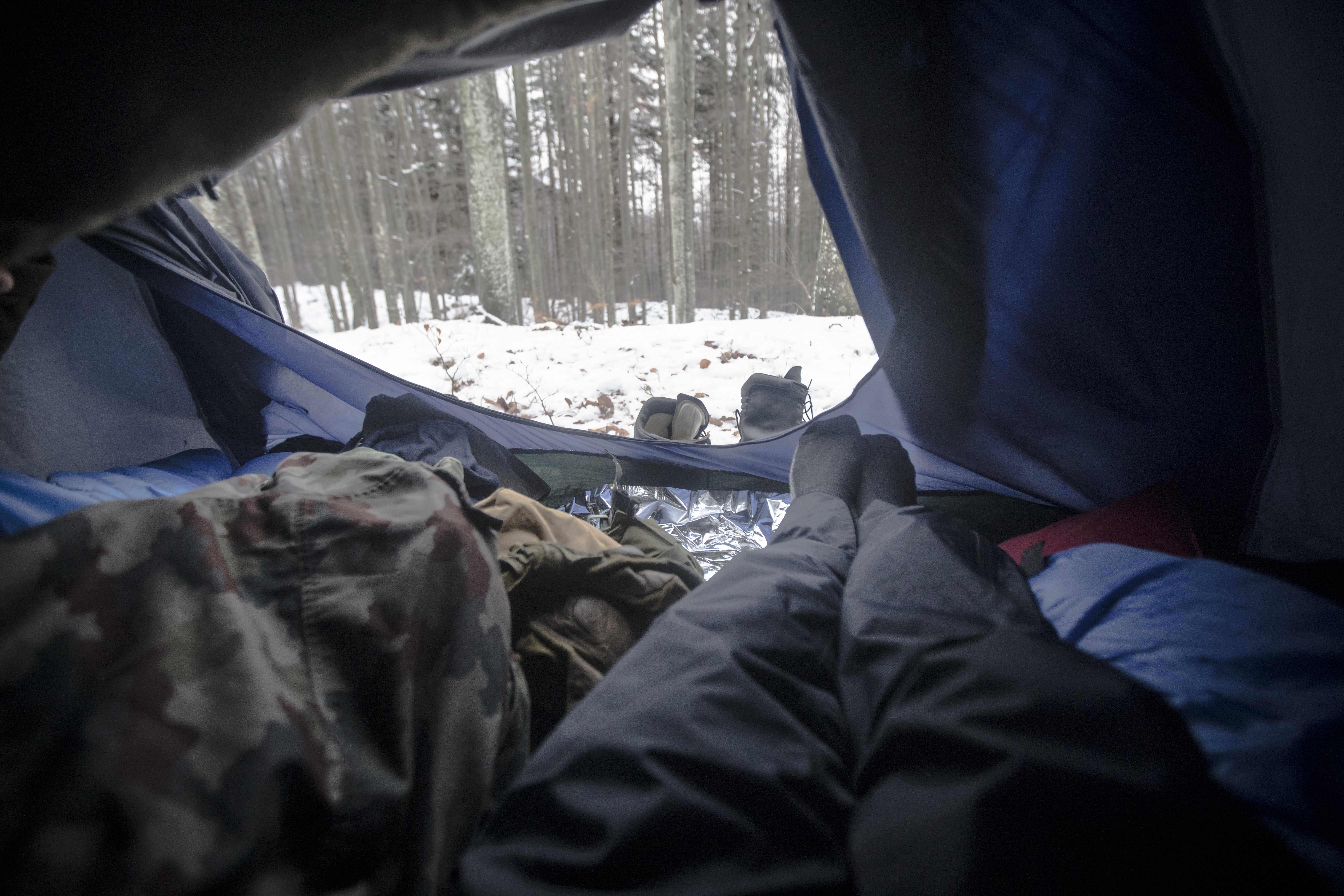 Personal Perspective of a Man Camping in Winter Forest.