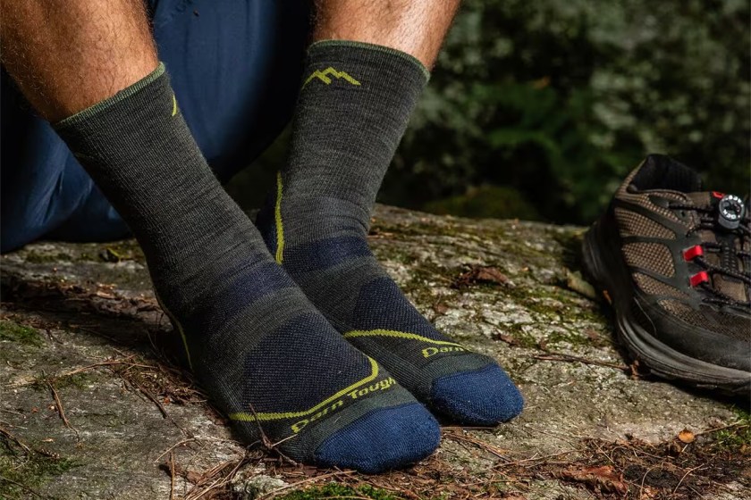 Person wearing gray darn tough socks with the photo zoomed in on their feet