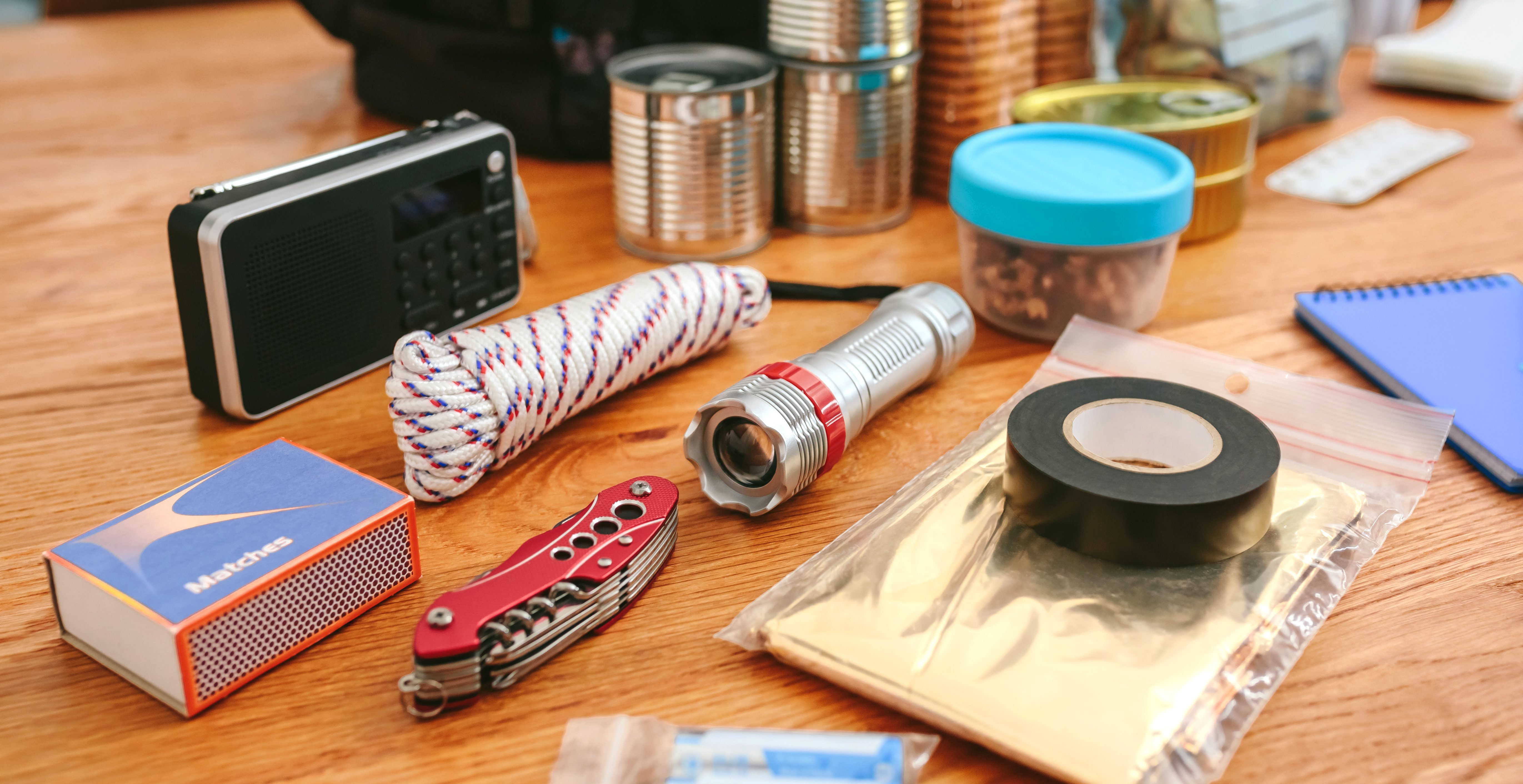 best bug out bags - Emergency backpack equipment organized on the table in the living room