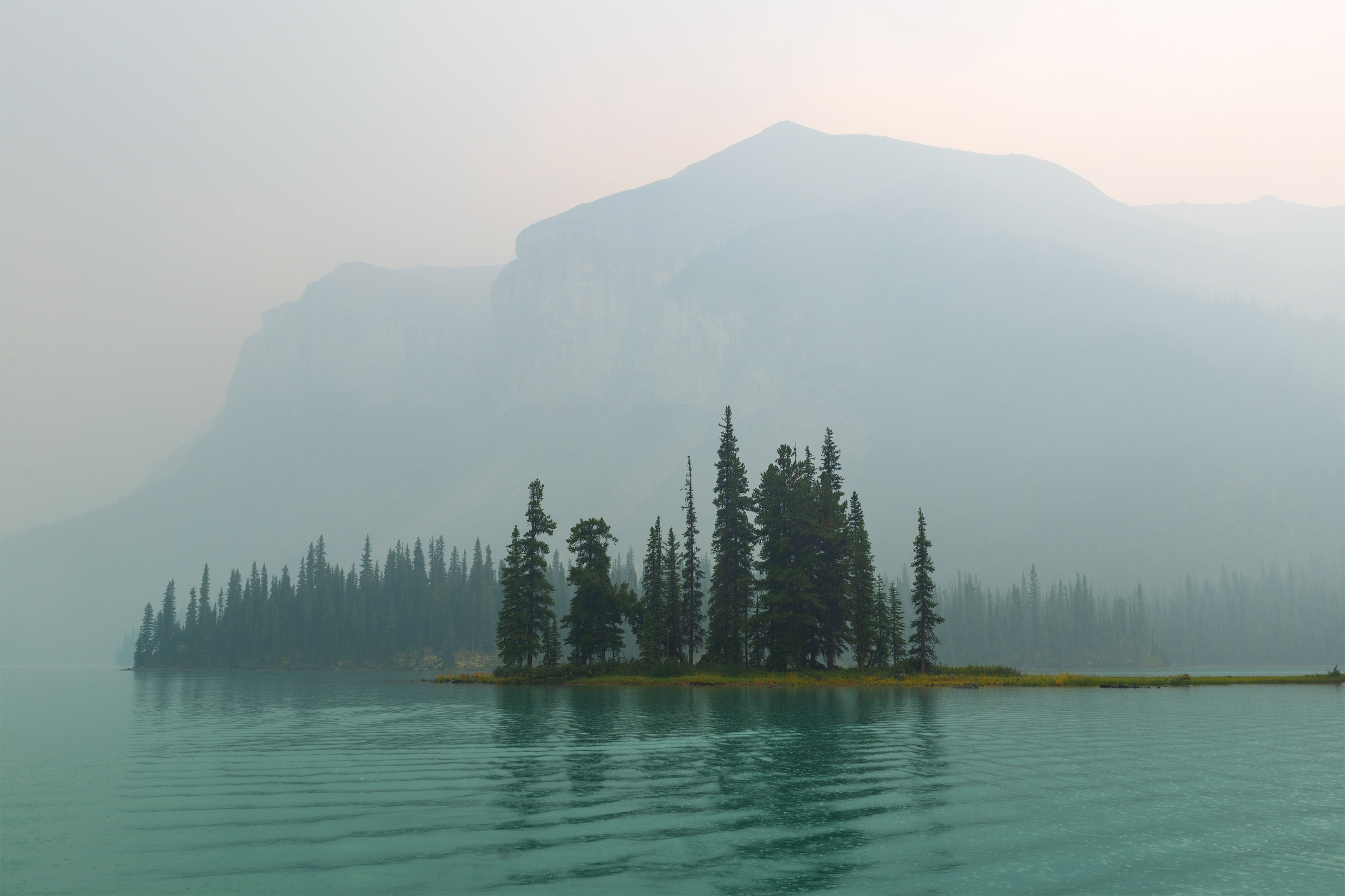 Spirit Island and Maligne Lake in wildfires smoke, Jasper national park, Canada.