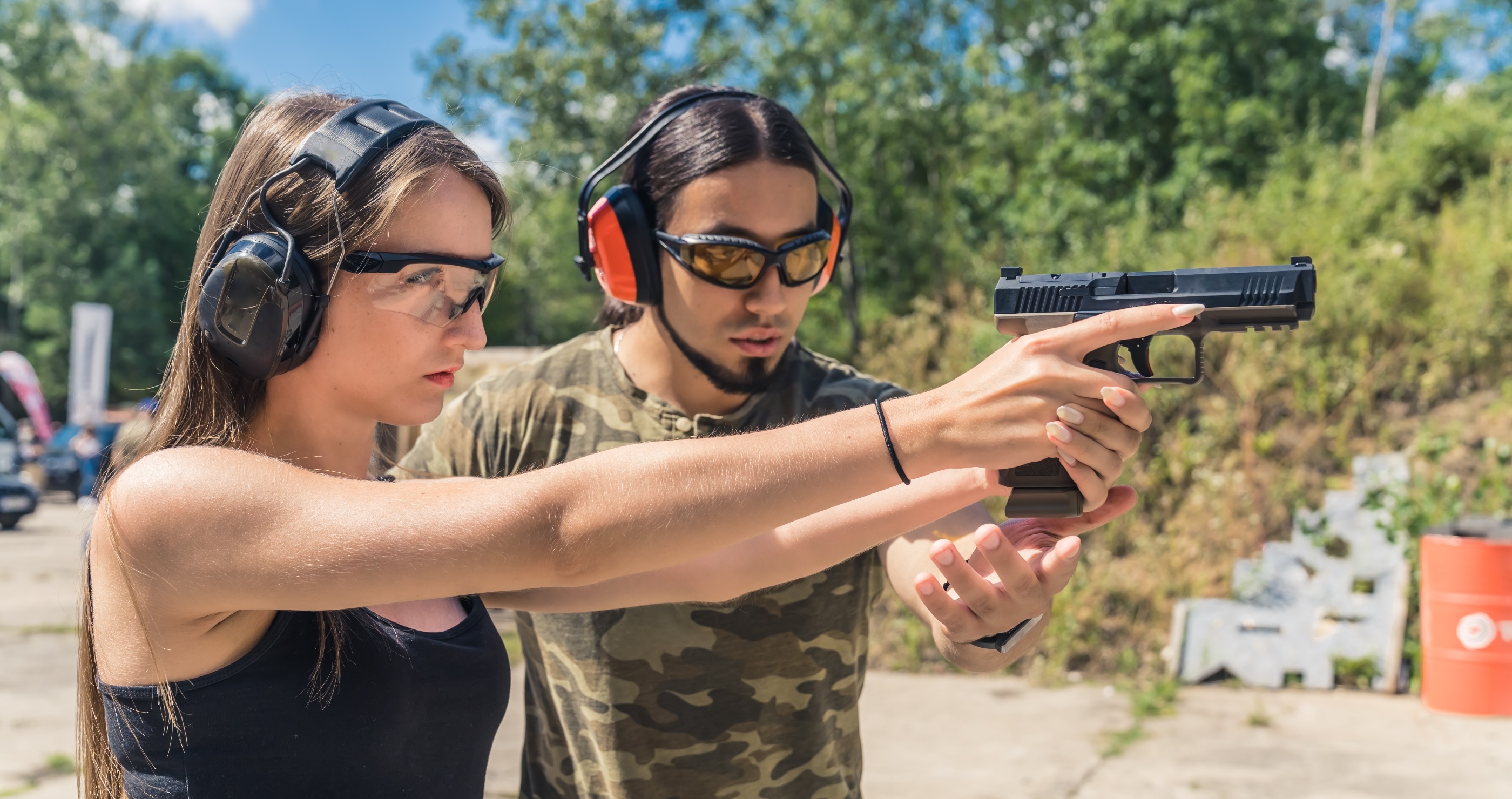 man showing a woman gun safety