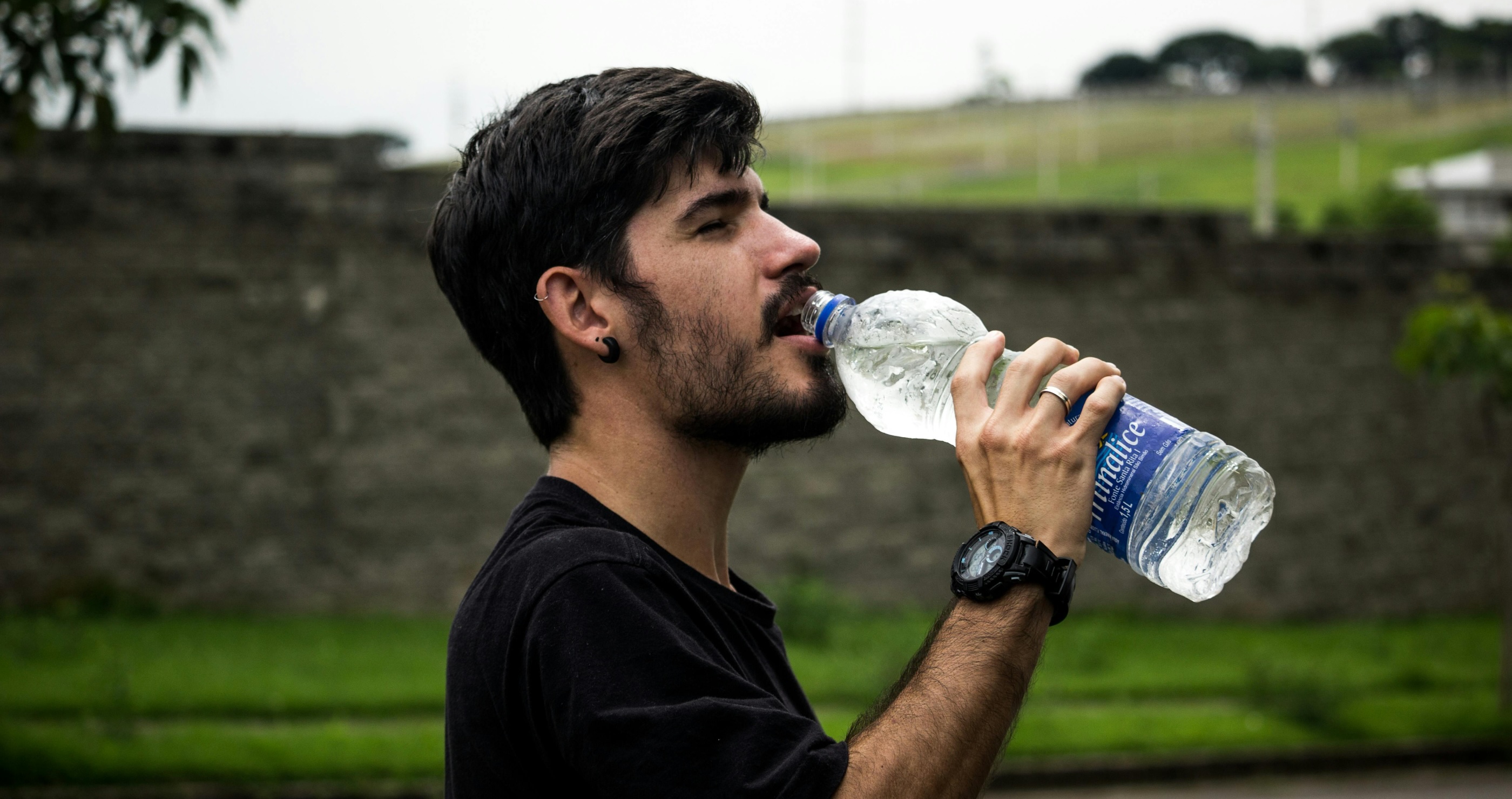 stay hydrated man drinking bottle of water